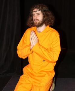 As Jesus, Abie Philbin Bowman goes from telling jokes to delivering commentary on the conditions at Guantanamo Bay.
