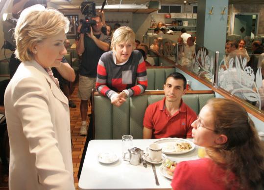 Senator Hillary Rodham Clinton and talk-show host Ellen DeGeneres (center) chat with patrons at a diner in New York. Clinton appeared on 'Ellen' on Tuesday.