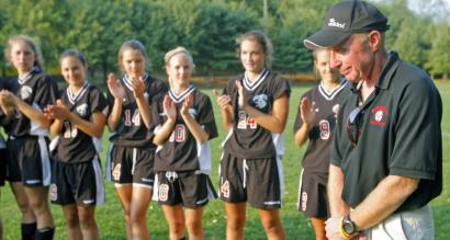 Winchester soccer coach Chris Scanlon is applauded after recording his 500th career win.