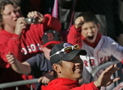 The sea of fans surged and chanted, ran alongside as fast as they could, and stretched as far as anyone on the duck boats could see, in this case Daisuke Matsuzaka.