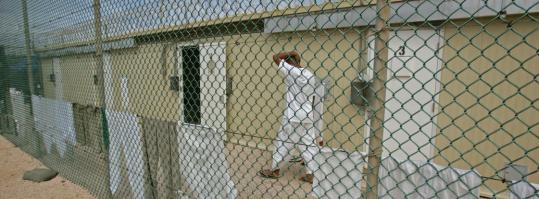 A detainee walked past cell doors last month at the Guantanamo Bay detention facility in Cuba.