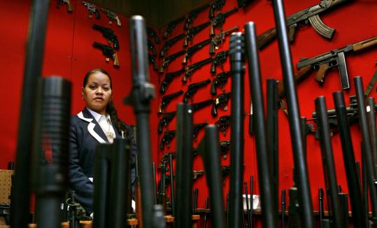 Karen Wiggins, head of Washington Metropolitan Police Department's firearms division, stood among a collection of the guns seized under a law that bars gun ownership in the District of Columbia for nearly everyone except law enforcement.