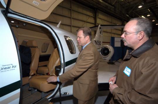 Linear Air chief executive Bill Herp, showing attendee Phil Butler the company's very light jet.