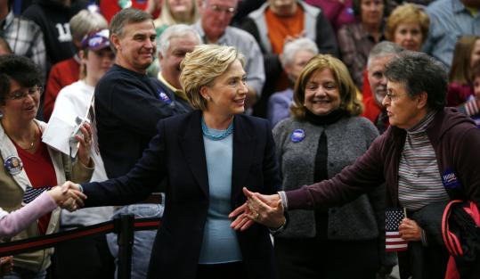 Hillary Clinton greeted the public Wednesday before speaking in Independence, Iowa. Her campaign strategy now includes exhibiting a warmer, more personable image. However, her supporters continue to criticize rival Barack Obama.