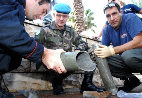UN peacekeepers from Italy and France examined the remains of a rocket fired from Lebanon into the northern Israel town of Shlomit in one of two attacks reported yesterday.
