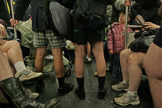 Emily Nye, 5, looked up in seeming bewilderment as she and her parents, who are visiting from England, were surrounded by pantless people on the Red Line yesterday. Boston was one of the 10 cities that took part in the 'No Pants! Subway Ride.'
