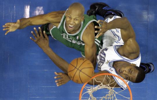 Ray Allen (1 rebound) tries his best against the Magic's Dwight Howard (16 rebounds).
