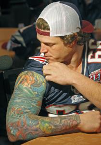 Lonie Paxton is a decorated long snapper, whether you're talking about Super Bowl rings or the tatoos on his arm.