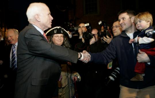 John McCain greeted Andrew McDonald and his son, Luke, yesterday at the Green Dragon Tavern near Faneuil Hall.
