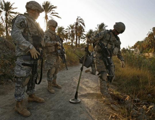 US soldiers from the 52d Infantry searched for roadside bombs near Baquba in December. US commanders estimate that forces now find and clear more than 50 percent of all IEDs in Iraq.