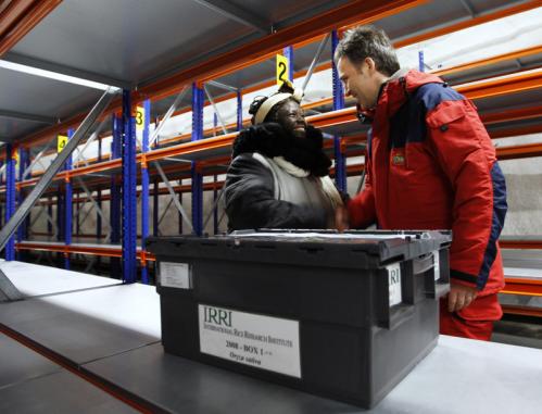 Nobel Peace laureate Wangari Maathai (left) of Kenya and Prime Minister Jens Stoltenberg of Norway greeted each other next to 'Box 1,' the first of many sealed cases containing seeds to be kept in the Svalbard Global Seed Vault.