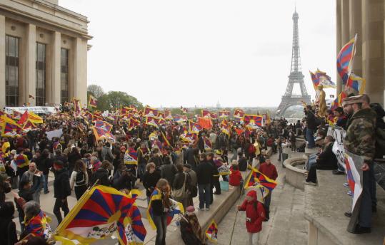 Pro-Tibet protesters rallied yesterday in Paris near the Eiffel Tower during the Olympic flame relay. Demonstrators clashed with police and forced the flame onto a bus several times.