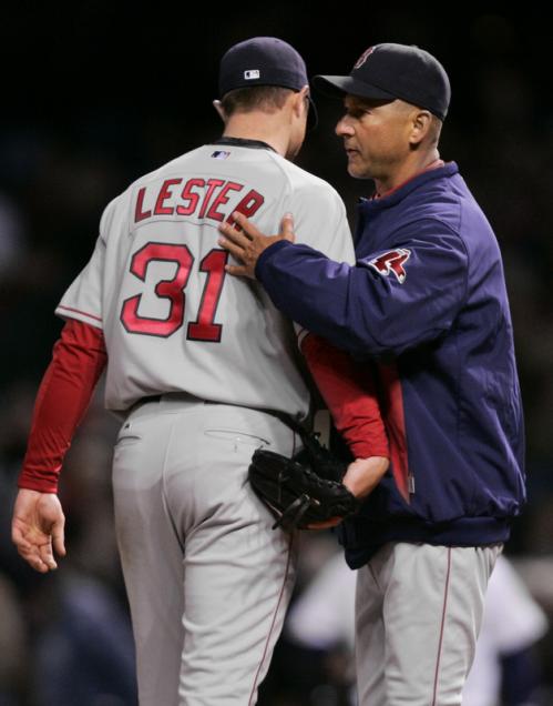 Boston Red Sox manager Terry Francona, right, pats starting pitcher Jon Lester on the back as he calls to the bullpen in the fifth inning.