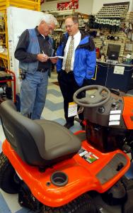 Wayne St. John (left) of the family-run Fireside True Value sold a lawn tractor last week to David Dunn of Dummerston.