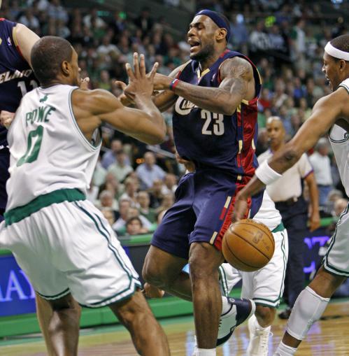 Celtics captain Paul Pierce (right) strips the ball from the Cavaliers' LeBron James (center) as he drives to the hoop in second half action. Leon Powe is at left.