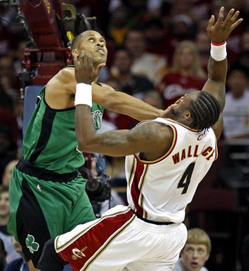 Celtics forward P.J. Brown plays some in-your-face defense as Cleveland center Ben Wallace (4) puts up a second-quarter shot.