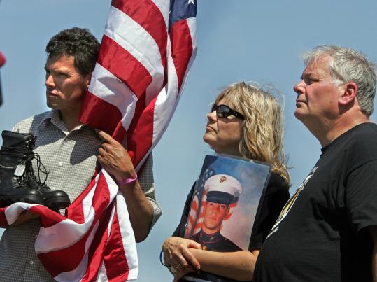 Carlos Arredondo (left) held a boot yesterday representing his son, Alexander, who died fighting in Iraq. Standing beside him were Joyce and Kevin Lucey, whose son Jeffrey killed himself after returning from the war in Iraq.