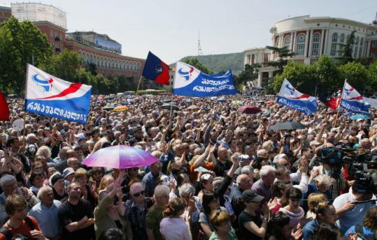 About 50,000 opposition supporters yesterday marched across Tbilisi, the Georgian capital, to protest parliamentary election results they said were rigged in favor of the ruling party.