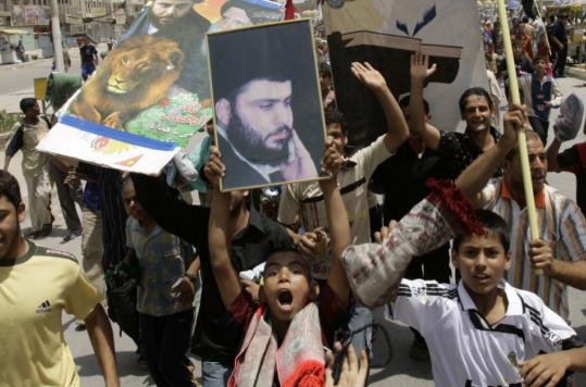 Demonstrators shouted slogans in Baghdad's Sadr City district as they held placards of cleric Moqtada al-Sadr. Tens of thousands of protesters took to the streets in Baghdad and other cities.