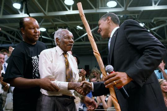 Charles Edwards, 95, shook hands with Senator Barack Obama yesterday after presenting him with a handmade walking stick during a town hall meeting at Virginia High School in Bristol, Va. Obama hopes to wrest the state from Republicans in November.