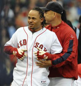 Terry Francona ushers Coco Crisp away from the brawl that began when Crisp charged the mound after being hit.