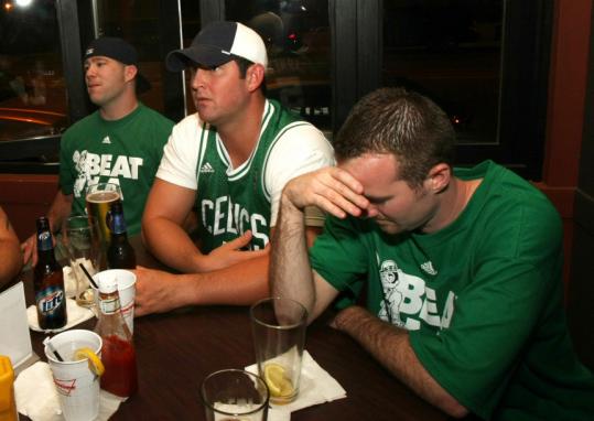 Dan Cooney, Mike Fontaine, and Jon Montcrieff, at the Stadium Sports Bar and Grill in South Boston last night, reacted to an early Lakers lead.