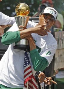 Paul Pierce, clutching the NBA Finals MVP trophy, smokes a victory cigar yesterday during the Celtics' victory parade.