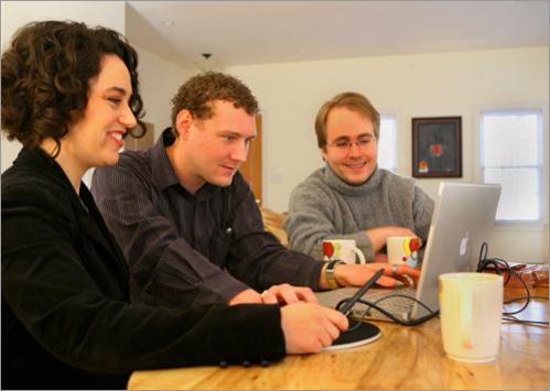 The couple meet with graphic designer Dan Harkins, center, as they work on the design of their wedding invitations at their Cambridge home in March.