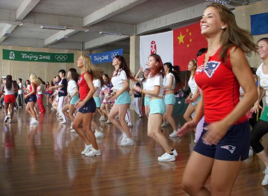 New England Patriots cheerleader Julie Warner (far right) and other members of the squad lead a class in Beijing.