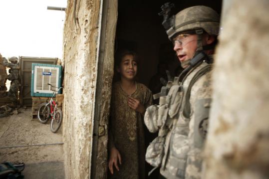 An Iraqi girl reacted as a US soldier searched her family's home yesterday in Sa'ada, north of Baghdad in Diyala province.