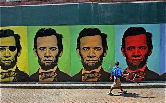 The mural by artist Ron English on Harrison Avenue features composite portraits of Barack Obama and Abraham Lincoln, their faces melded in a rainbow of colors.