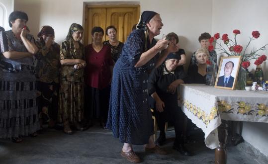 Mikhail Metzel/Associated PressRelatives mourned during the wake of Vazha Bestaev of South Ossetia, seen in a photo on the table, in the town of Ardon, Russia. He died in recent fighting in Tskhinvali.