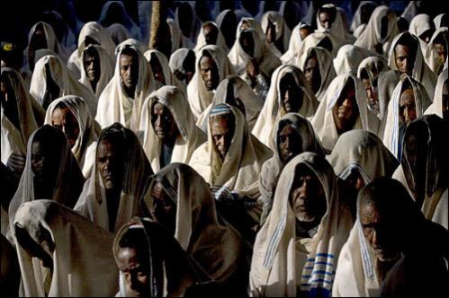 Ethiopian Jewish men wearing prayer shawls pray during Shabbat services on Aug. 12, 2008 in a synagogue in Gondar, Ethiopia. Some 40,000 Ethiopian Christians with claims to Jewish ancestry, known as the Falash Mura, have been brought to Israel in a campaign led by American Jews that has touched off a fierce debate over whom the Jewish state is obliged to accept. The immigration is supposed to end this month, as Israel seeks to stem what it fears could be a flood of African migrants with only tenuous links to Judaism.