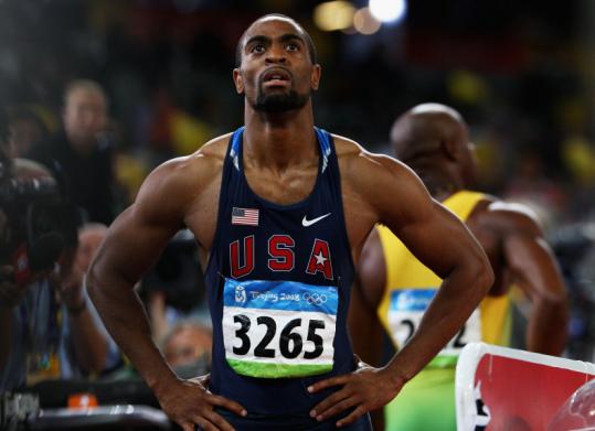 Tyson Gay looks at the scoreboard in frustration at the Olympics.