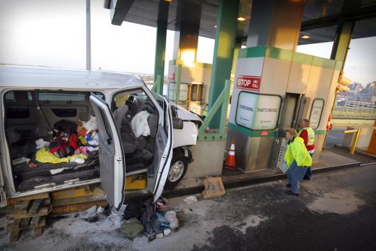 Workers viewed the damage after a passenger van headed south crashed into a barrier on the Tobin Bridge yesterday. The victims were taken to Mass. General and Tufts Medical Center.