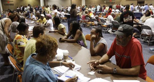 New Orleans residents fill out applications for emergency food stamps last week after Hurricane Gustav. The storm also caused major job loss there.