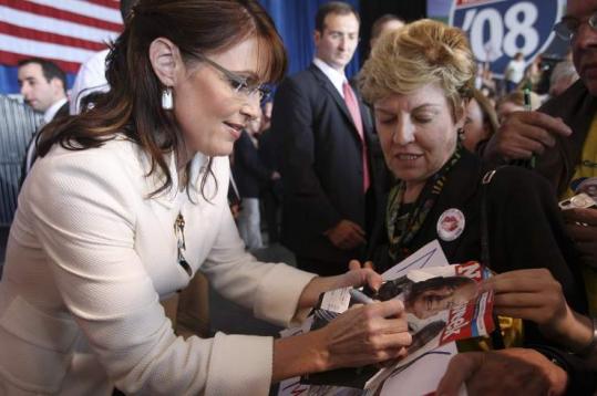 Sarah Palin signed an autograph for a voter yesterday in Cedar Rapids, Iowa. Palin also apologized to community organizers who felt slighted by her comments at the GOP convention.