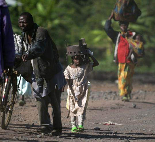 Displaced Congolese leave Goma, where rebels halted their advance Wednesday and called for a cease-fire.