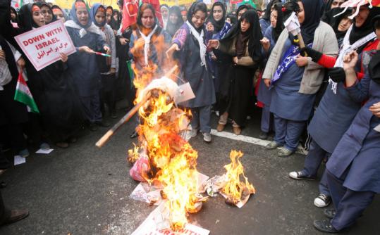 Iranian schoolgirls burned an effigy of Condoleezza Rice yesterday outside the former US Embassy in Tehran.