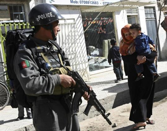 AFGHAN VIOLENCE - An Afghan policeman stood guard in Kabul yesterday. Gunmen kidnapped a French aid worker yesterday and shot dead an Afghan driver for the national intelligence agency who tried to stop the abduction, a senior police officer said.