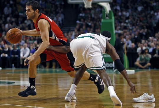 Rajon Rondo reaches for his shoe and Jose Calderon after losing both in the third quarter.