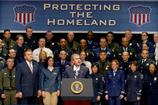 The Department of Homeland Security opened its doors in 2003. Above, President Bush spoke at a ceremony marking the first day with then-Secretary Tom Ridge (second from left).