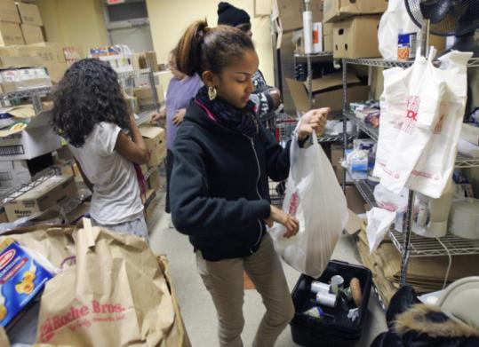 Ashley Rosario-Pena, 11, and her sister Tiffany, 15, volunteer at Catholic Charities' Yawkey Center, which has added hours.