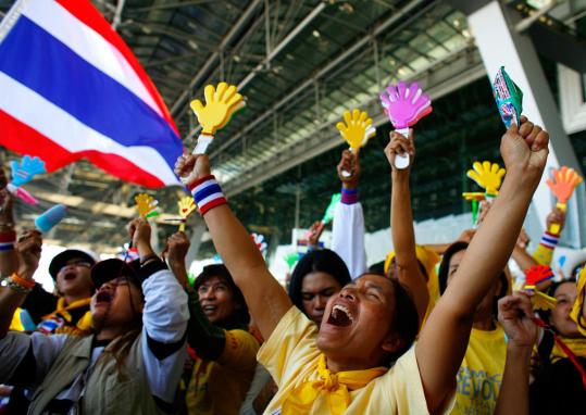 Demonstrators from the People's Alliance for Democracy cheered in declaring victory near the end of their siege at Suvarnabhumi international airport in Bangkok yesterday.