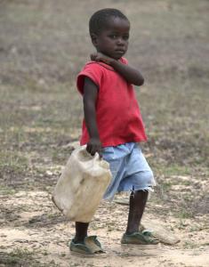 A boy carried a container to fetch water yesterday in Mutare, Zimbabwe. South Africa is sending more military doctors to treat Zimbabwean cholera victims.