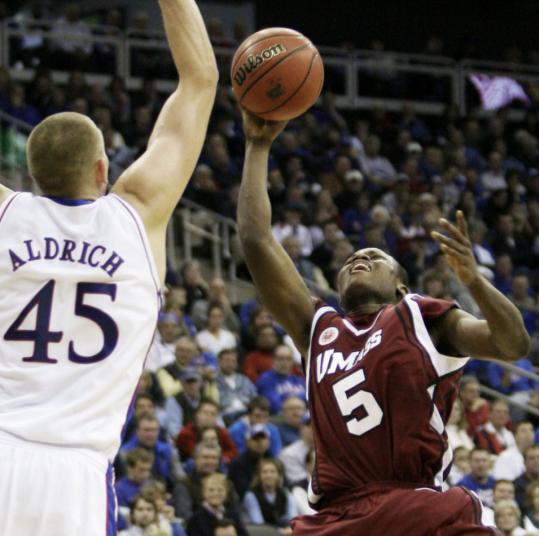 UMass guard Ricky Harris (18 points) has a big problem: Kansas's Cole Aldrich is in his way.