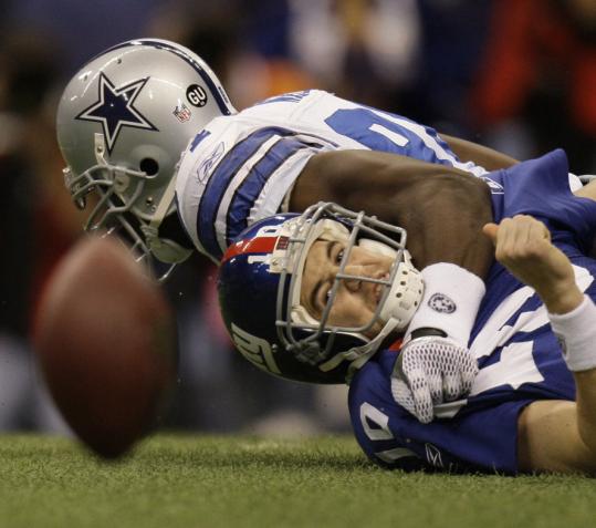 In a punishing performance, DeMarcus Ware had three of the Cowboys' eight sacks of Giants quarterback Eli Manning.
