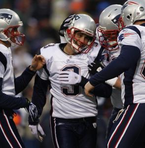 Stephen Gostkowski earns congratulations after kicking an extra point in the blustery wind.