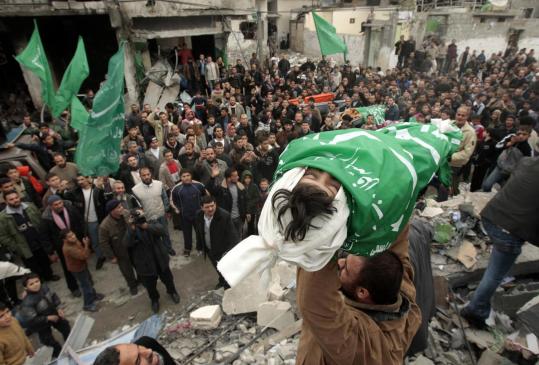 A relative carried the body of one of five young sisters who authorities said died in an air strike at Gaza's Jabalya refugee camp.