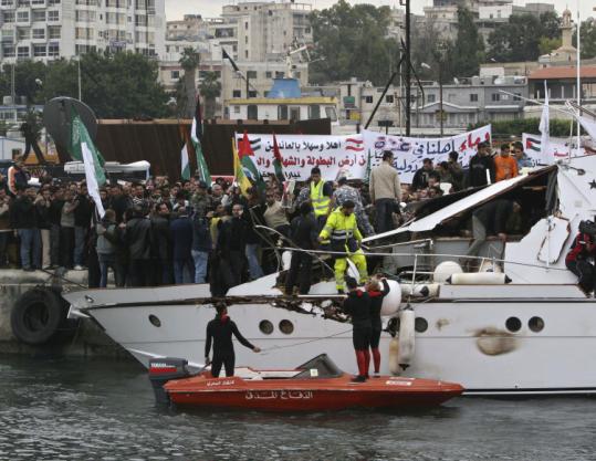 A crowd on a dock in Tyre, Lebanon, welcomed the vessel SS Dignity as it arrived yesterday. The boat carried peace activists and medical supplies.